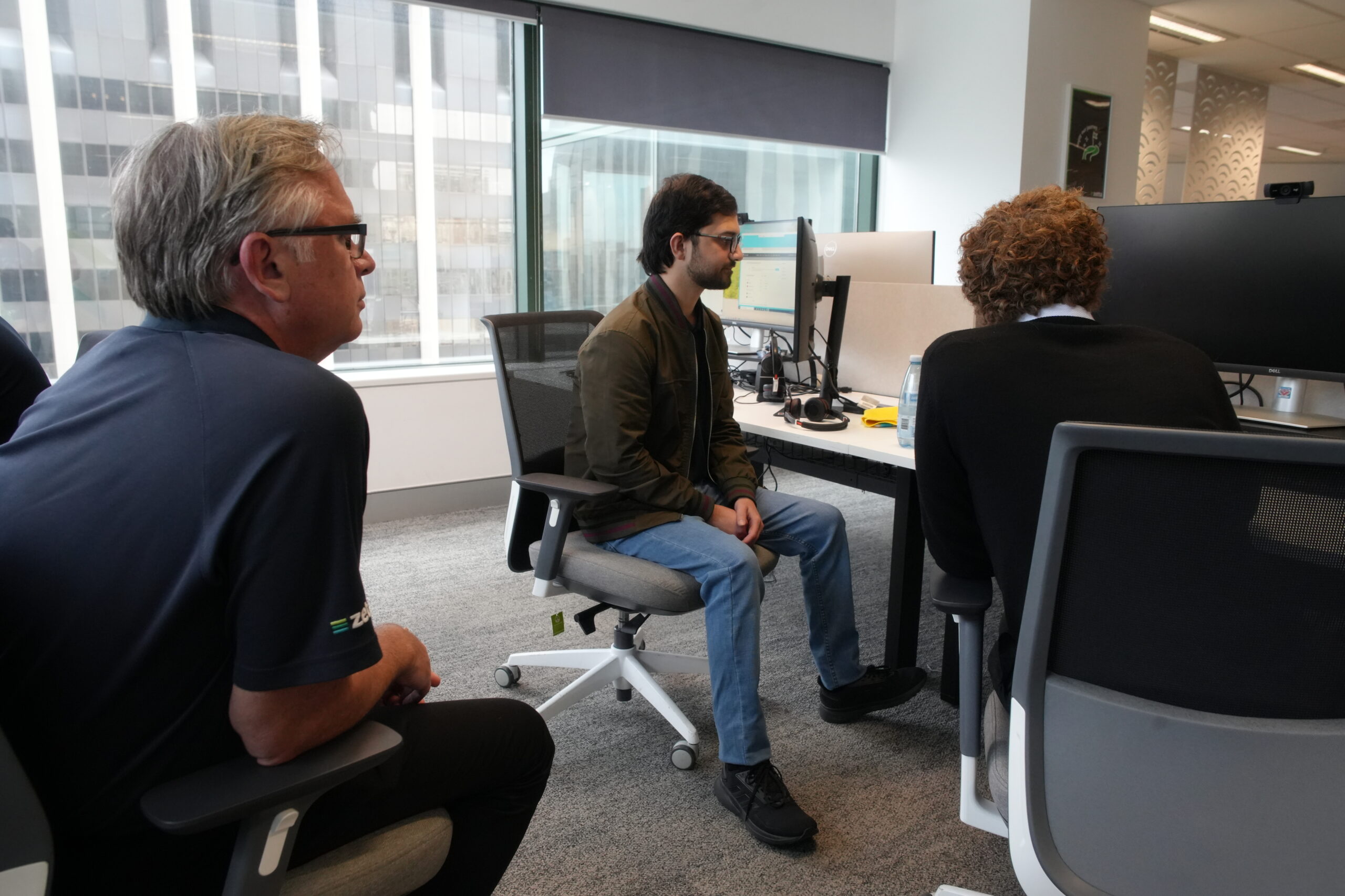 Three people collaborating on a computer problem