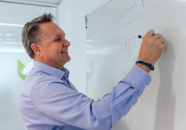 A Zetta consultant writing on a whiteboard in the Perth office